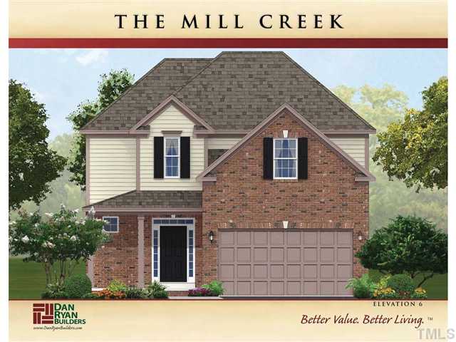 2524 Follow Me Way Raleigh, NC 27610 - Photo 1 of 5 a front view of a house with a garden and garage