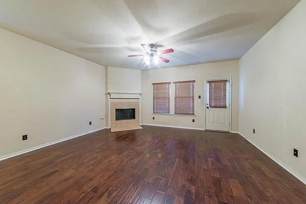 wooden floor in an empty room with a fireplace