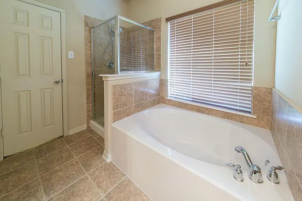 a bathroom with a bathtub and a shower