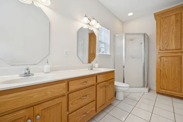 a view of an empty room and chandelier fan