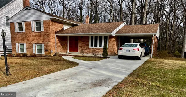 a front view of a house with cars parked