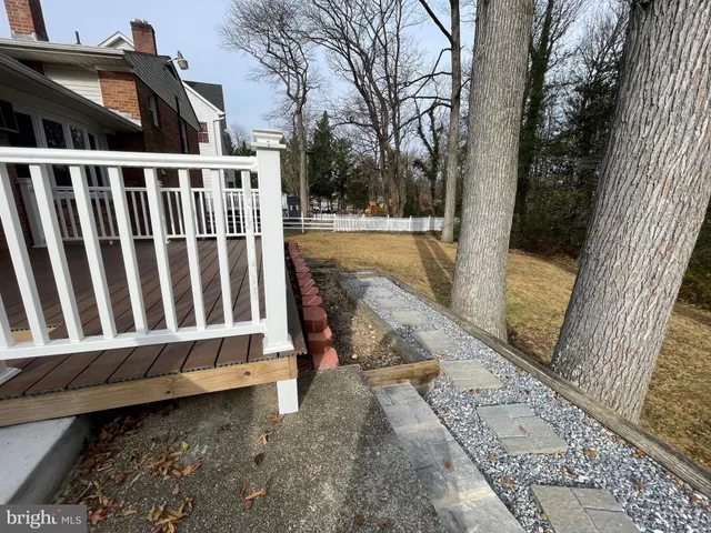 a balcony with wooden floor and fence