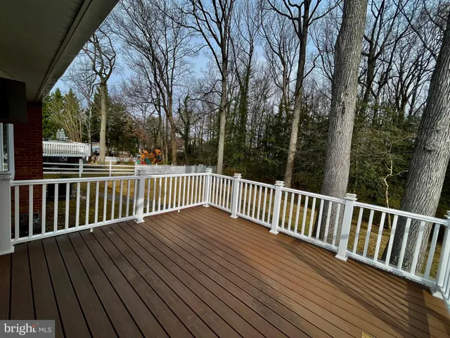 a view of a yard with wooden fence and trees