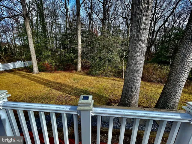 a view of a yard with wooden fence