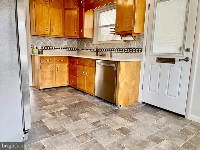 an empty room with closet and windows