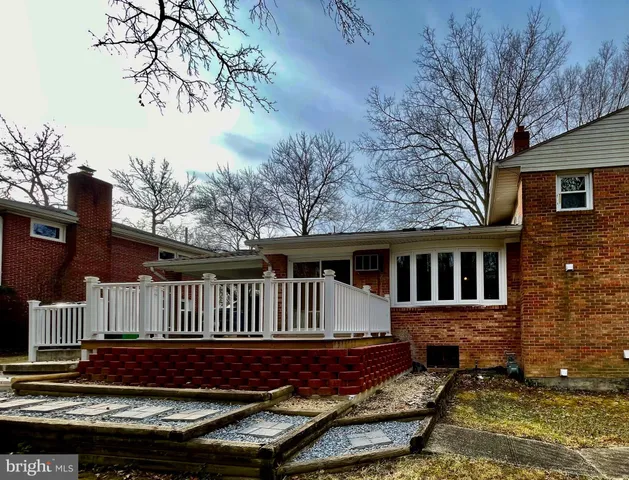 a view of a house with wooden fence