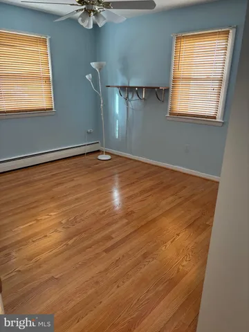 a view of an empty room with closet and a window