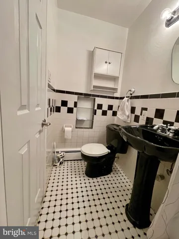 a view of an empty room with closet and a window