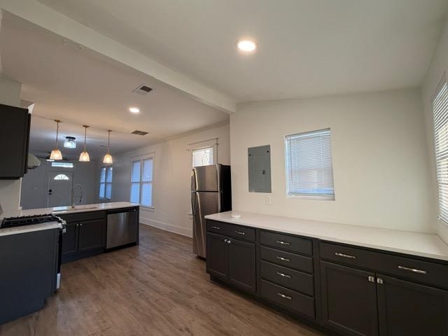 1073 Bruce Street Memphis, TN 38104 - Photo 4 of 12 a kitchen with stainless steel appliances kitchen island granite countertop a refrigerator and a stove top oven