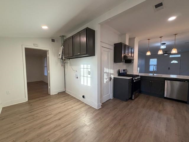 1073 Bruce Street Memphis, TN 38104 - Photo 5 of 12 a kitchen with stainless steel appliances kitchen island granite countertop a refrigerator and a stove top oven