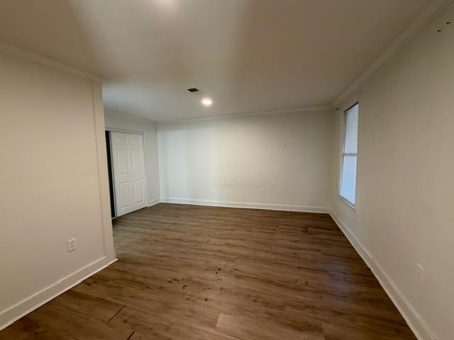 1073 Bruce Street Memphis, TN 38104 - Photo 6 of 12 a view of an empty room with wooden floor and a window