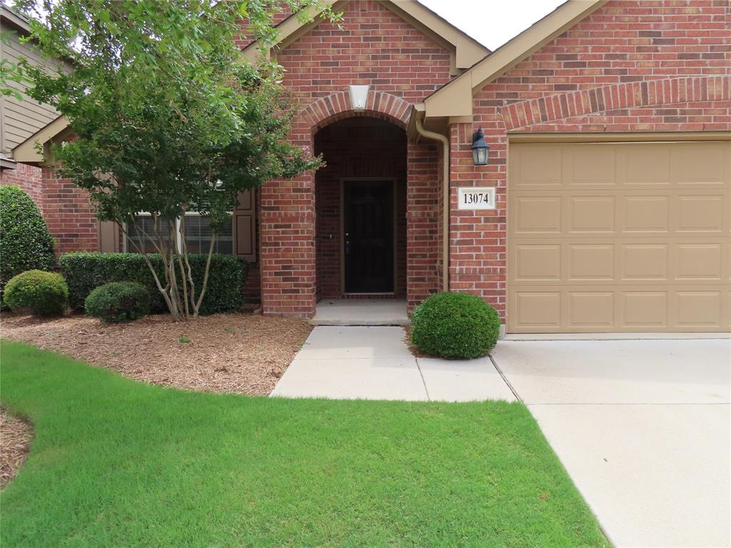 13074 Red Robin Drive Fort Worth, TX 76244 - Photo 1 of 1 a front view of a house with garden
