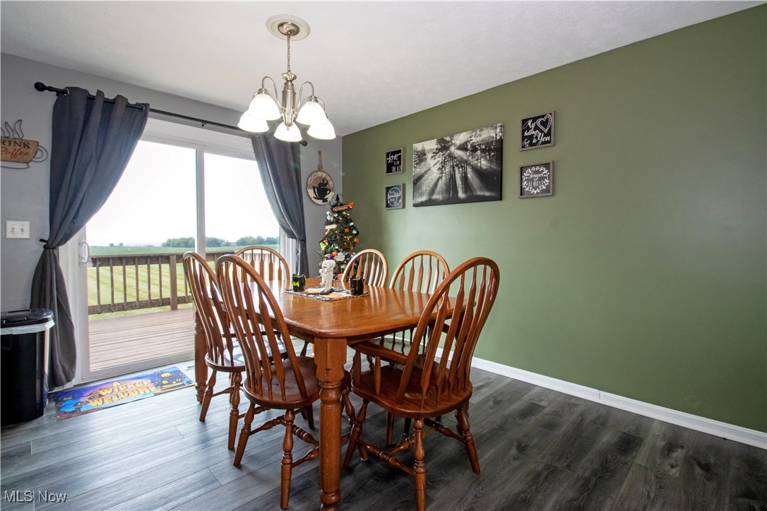 5530 Force Road Shreve, OH 44676 - Photo 9 of 23 Dining area with dark hardwood / wood-style floors and a notable chandelier