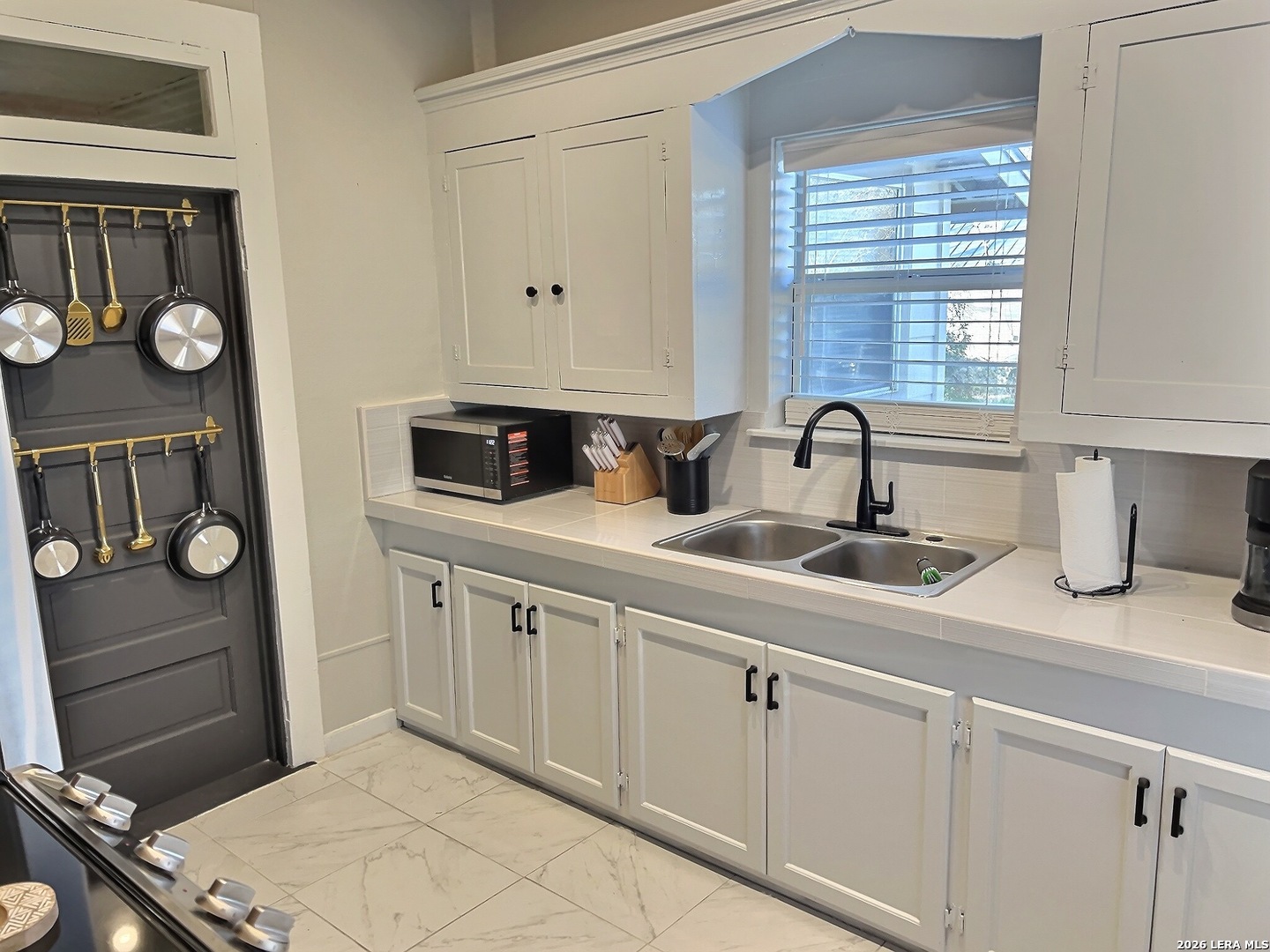 404 West Walnut Street Seguin, TX 78155 - Photo 11 of 32 a kitchen with cabinets appliances and a window
