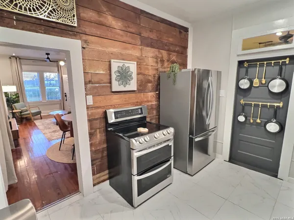 a kitchen with stainless steel appliances granite countertop a refrigerator and a stove