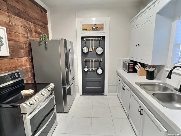 a kitchen with stainless steel appliances granite countertop a refrigerator and a stove