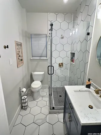 a bathroom with a sink toilet and shower