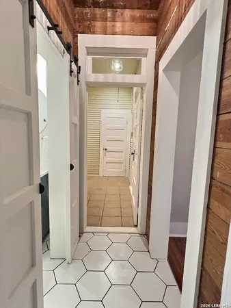 a view of walk in closet with hardwood