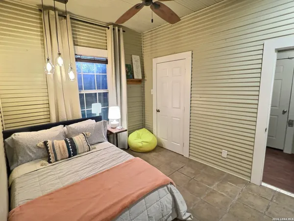 a bedroom with a bed and a window