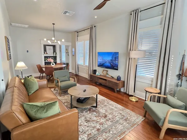 a living room with patio furniture and a flat screen tv