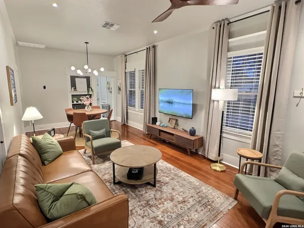 a living room with furniture and a chandelier