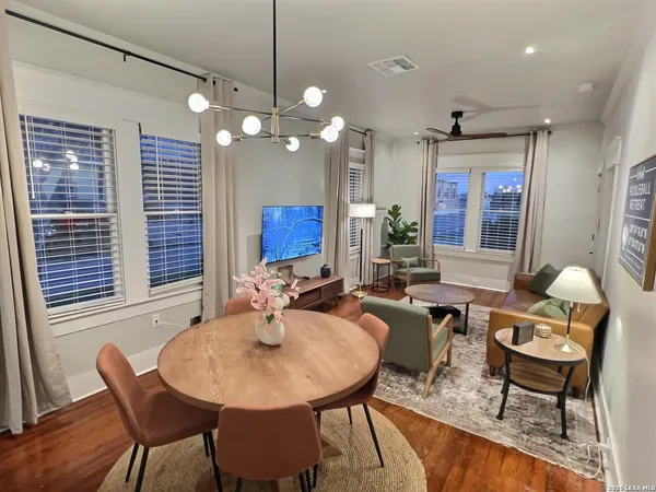 a view of a dining room with furniture window and wooden floor