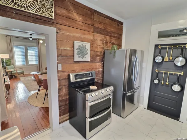 a kitchen with stainless steel appliances kitchen island granite countertop a refrigerator stove and stove