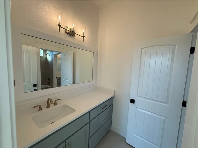 an empty room with a window and a ceiling fan