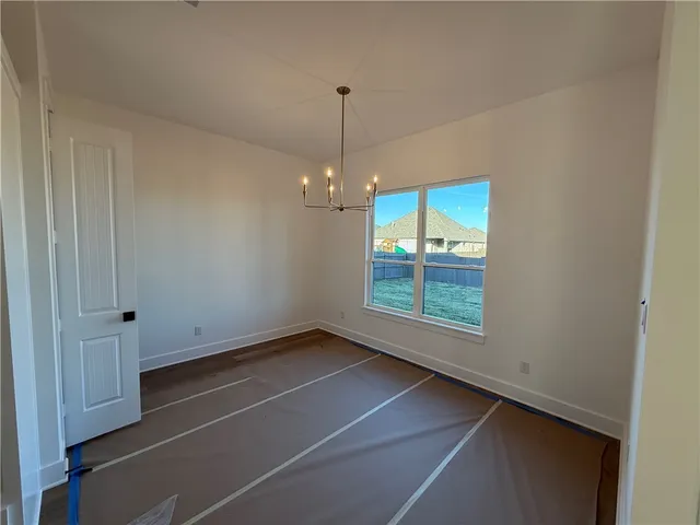 a view of an empty room with a fireplace and a window