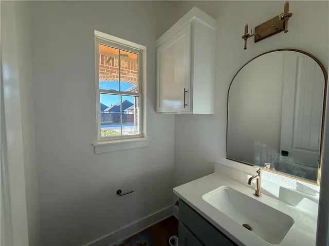 a bathroom with a window sink and mirror