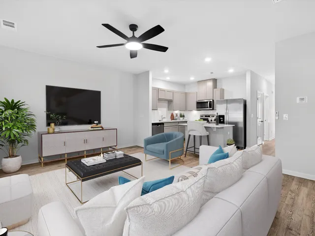 a living room with furniture and a flat screen tv