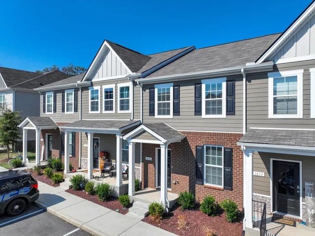 a front view of a residential apartment building with a yard