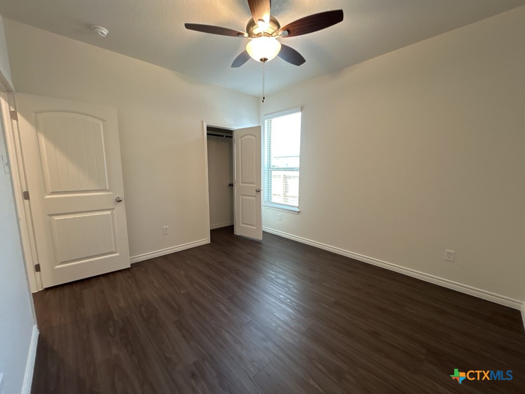 5110 Rose Gdn Loop Killeen, TX 76542 - Photo 15 of 19 an empty room with wooden floor ceiling fan and windows