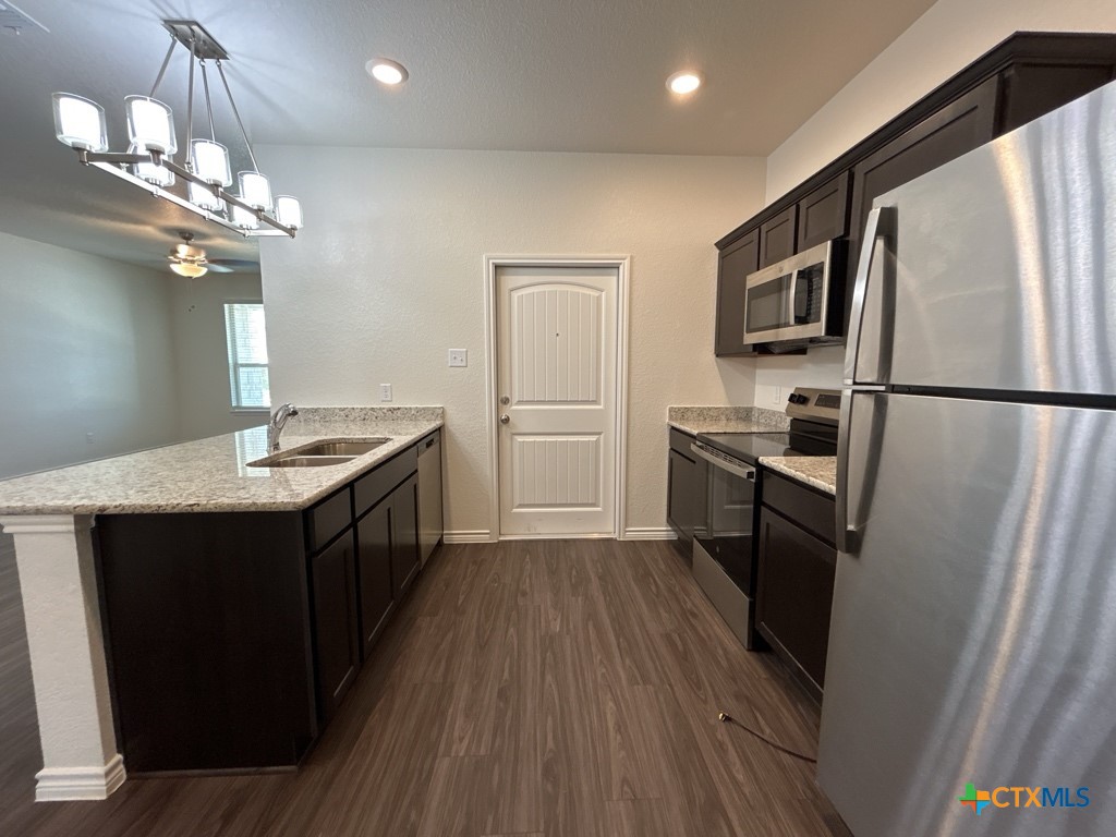 5110 Rose Gdn Loop Killeen, TX 76542 - Photo 7 of 19 a kitchen with refrigerator cabinets and wooden floor