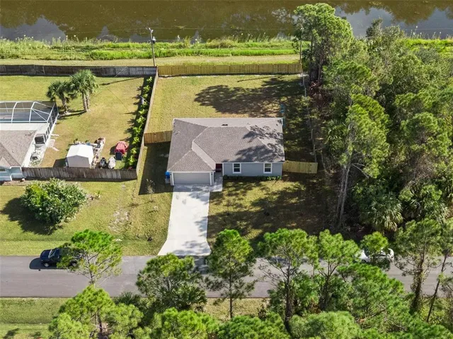 an aerial view of a house with a lake view