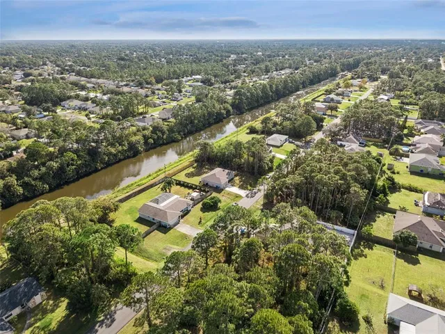 an aerial view of a houses with a lake view