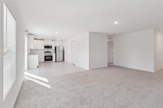 a view of kitchen and refrigerator