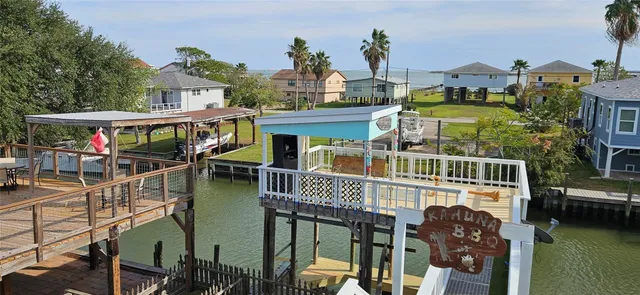 a view of a house with a backyard and porch