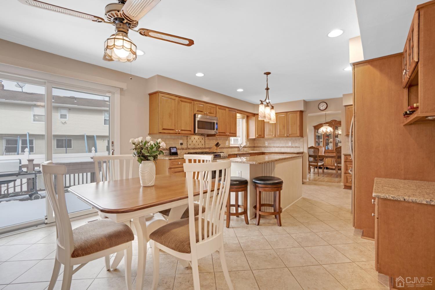 5 Diamond Drive Edison, NJ 08820 - Photo 13 of 35 a kitchen with stainless steel appliances kitchen island granite countertop a dining table chairs and granite counter tops