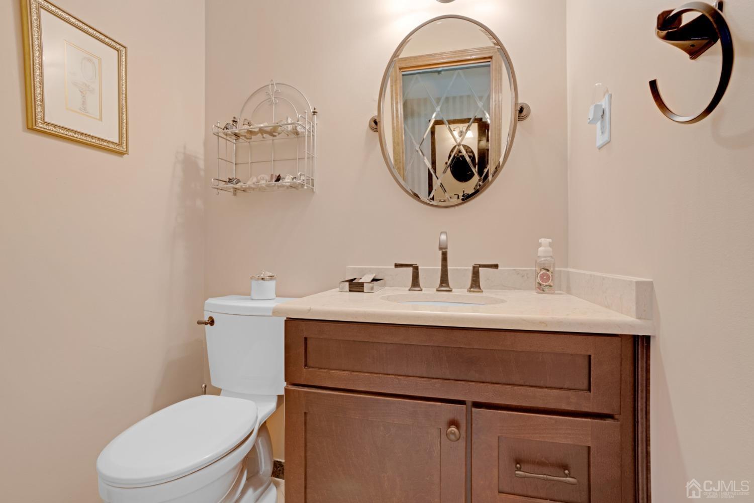 5 Diamond Drive Edison, NJ 08820 - Photo 19 of 35 a bathroom with a toilet a sink and mirror