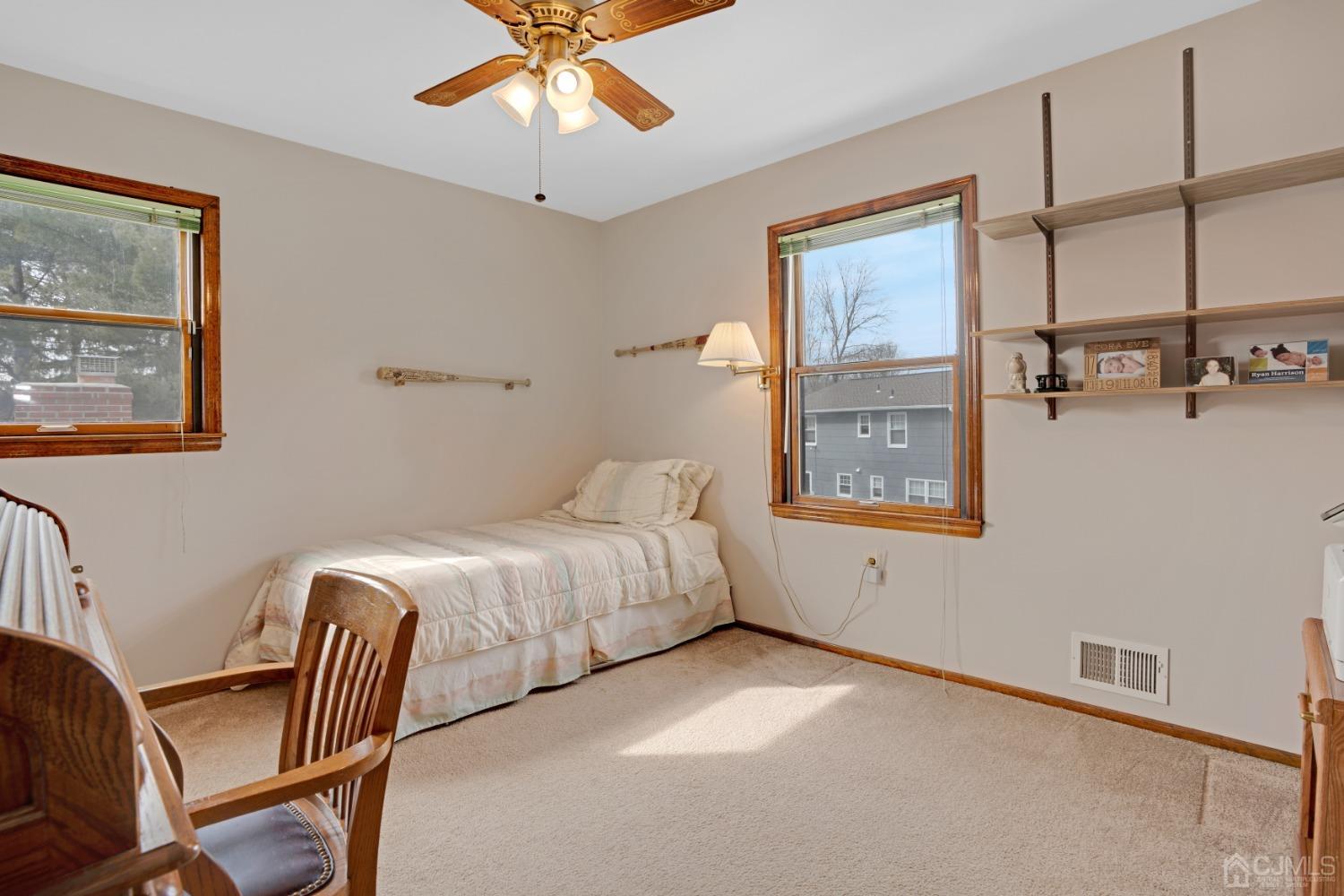 5 Diamond Drive Edison, NJ 08820 - Photo 24 of 35 a spacious bedroom with a bed a lamp on the wall and a window