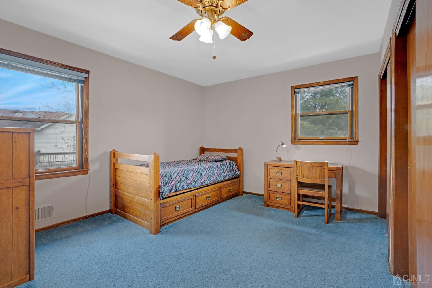 5 Diamond Drive Edison, NJ 08820 - Photo 26 of 35 a bed room with a bed and a chandelier