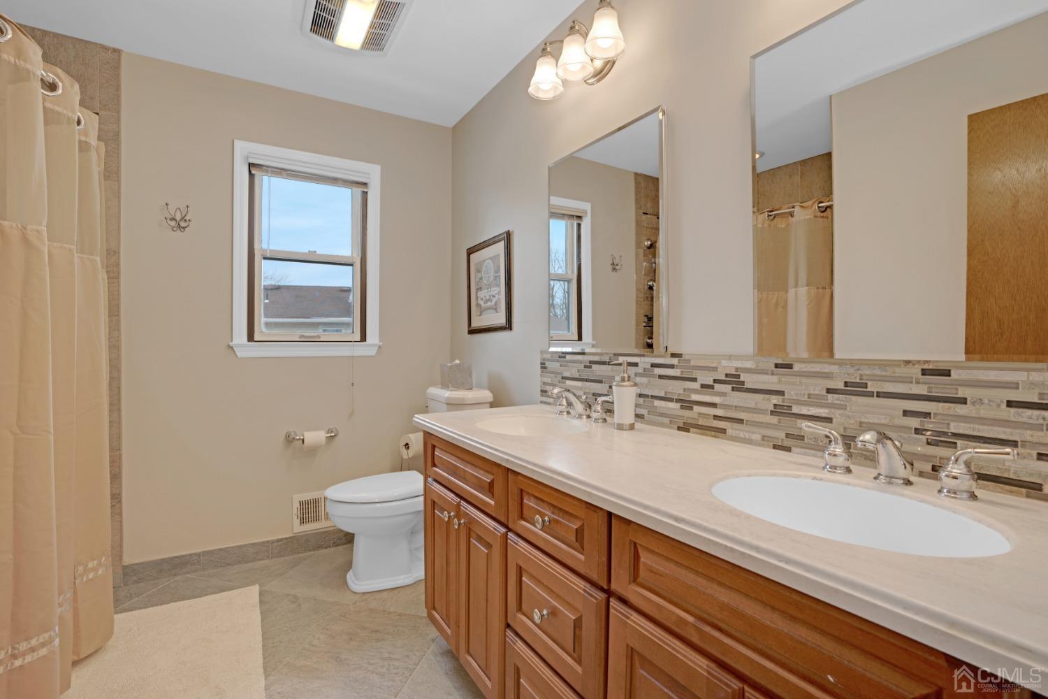 5 Diamond Drive Edison, NJ 08820 - Photo 28 of 35 a bathroom with a sink double vanity and a toilet