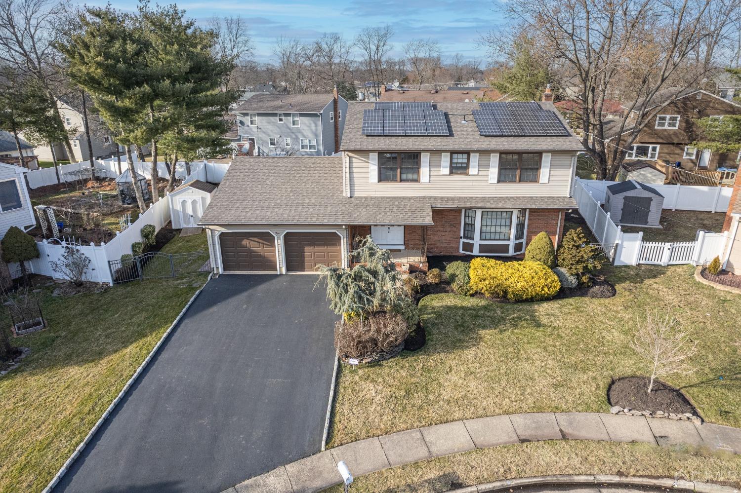 5 Diamond Drive Edison, NJ 08820 - Photo 4 of 35 a front view of a house with a yard covered with green space