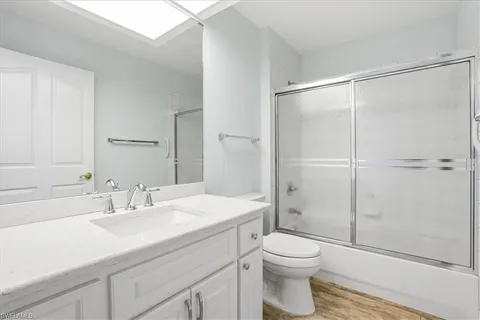 a bathroom with a sink toilet vanity and shower