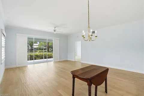 a view of a room with window wooden floor and chandelier