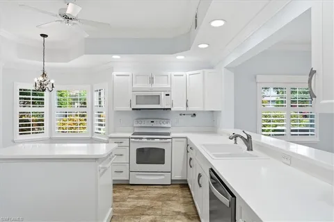 a kitchen with a stove a sink and a window