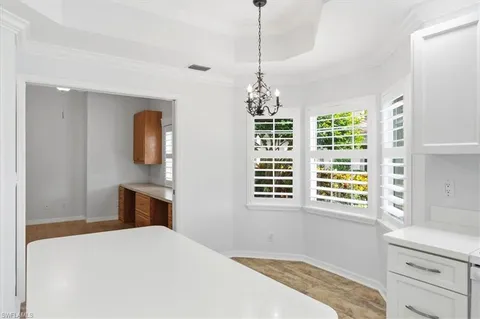 a bedroom with a bed and a dresser next to a window
