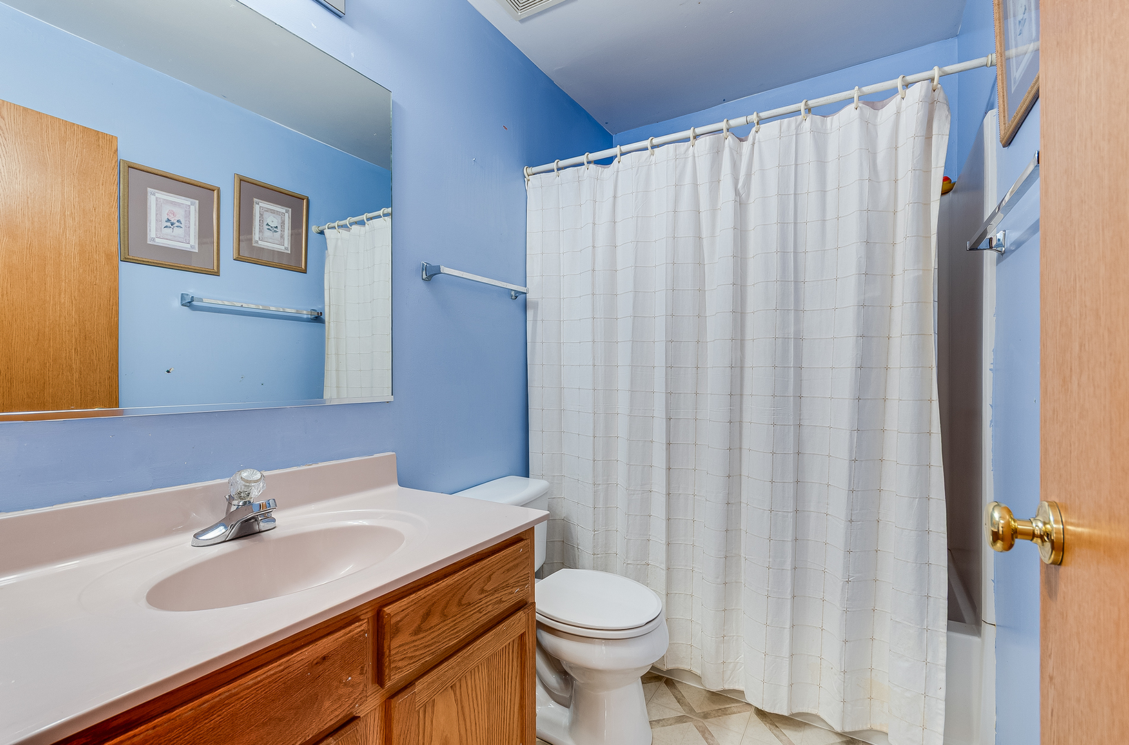 1544 Suncrest Lane Bolingbrook, IL 60490 - Photo 23 of 29 a bathroom with a sink a toilet and shower curtain