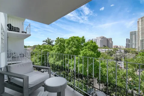 a view of a balcony with chair and table